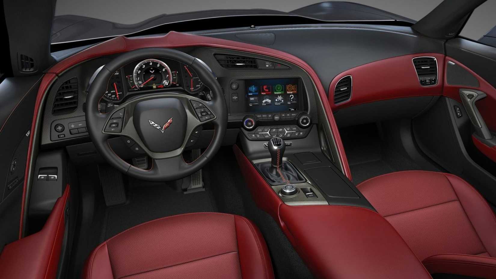 Shot inside the cabin of a 2014 Chevrolet Corvette C7 Stingray showing the red leather interior and dashboard.