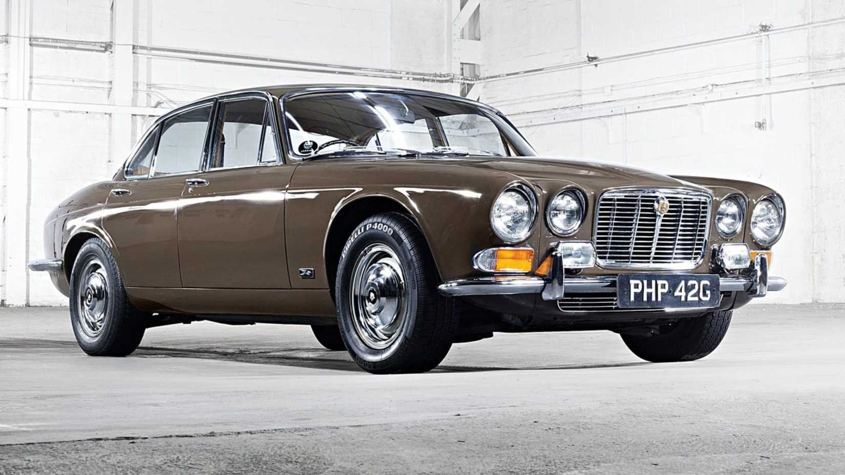 Still shot of a brown 1968 Jaguar XJ6 in 3/4 scale.