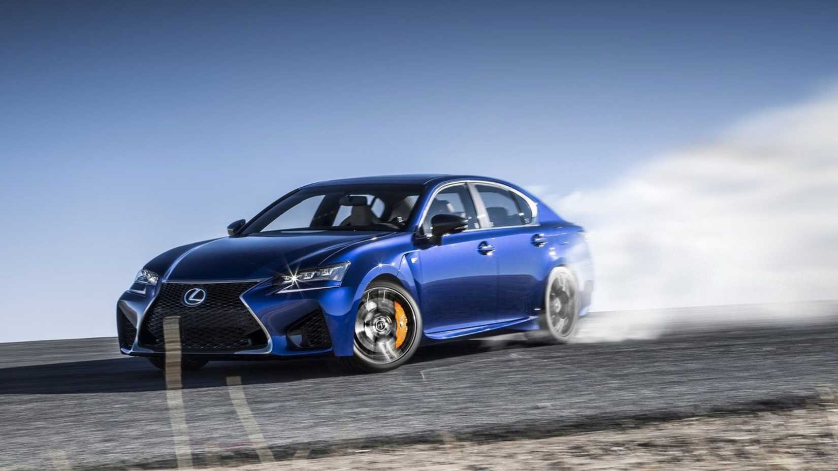 Toma dinámica de 3/4 del frente de un Lexus GS F 2016 azul a la deriva.