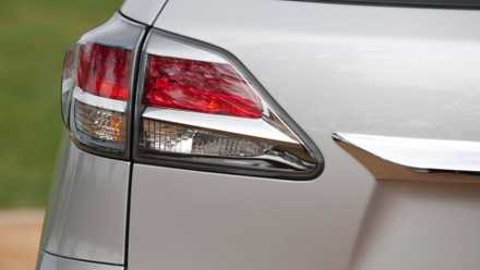 A close-up of the tail light on a silver 2013 Lexus RX 350 F Sport.