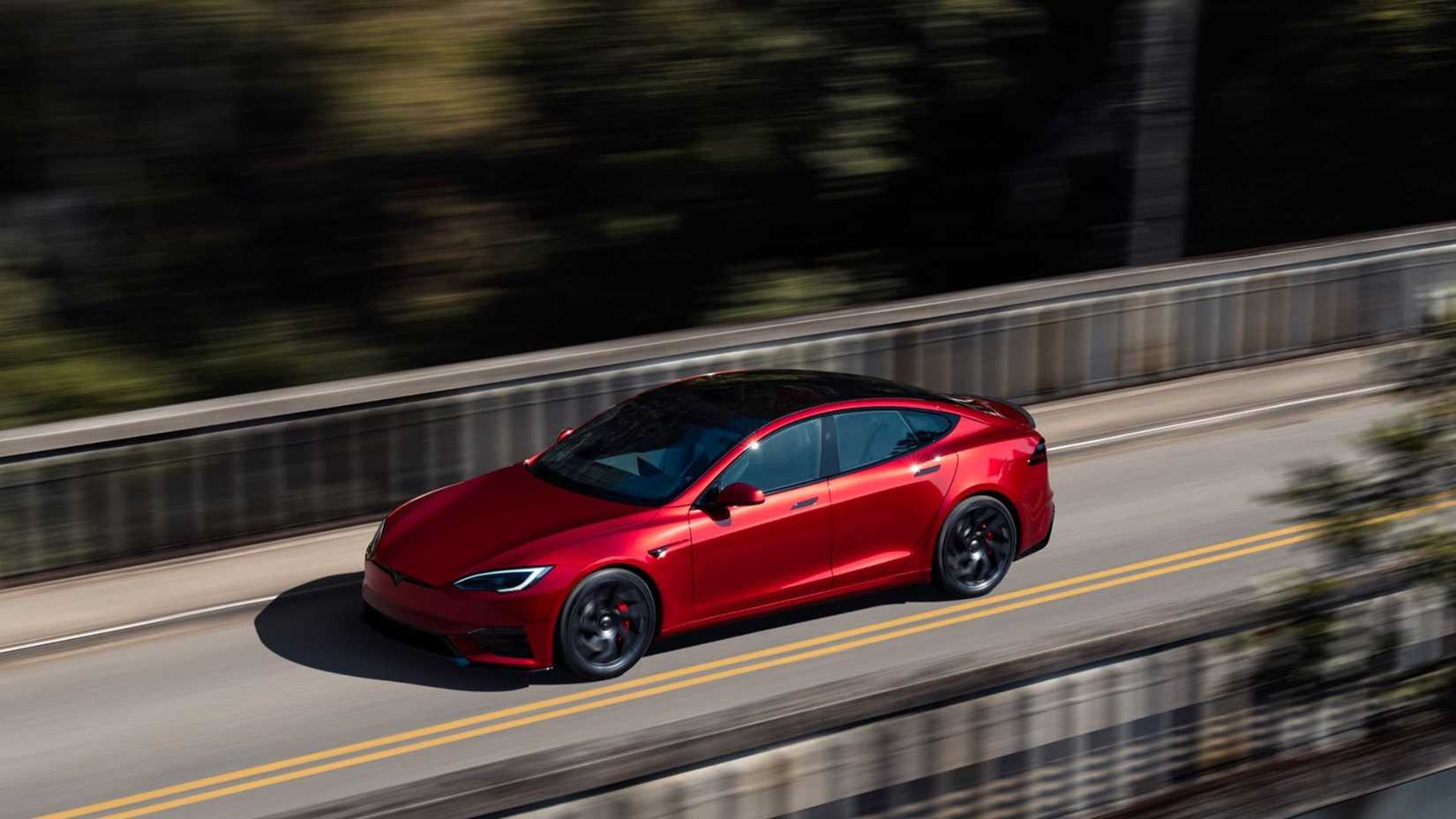 Dynamic shot of a red 2026 Tesla Model S Plaid from the front in 3/4 view.