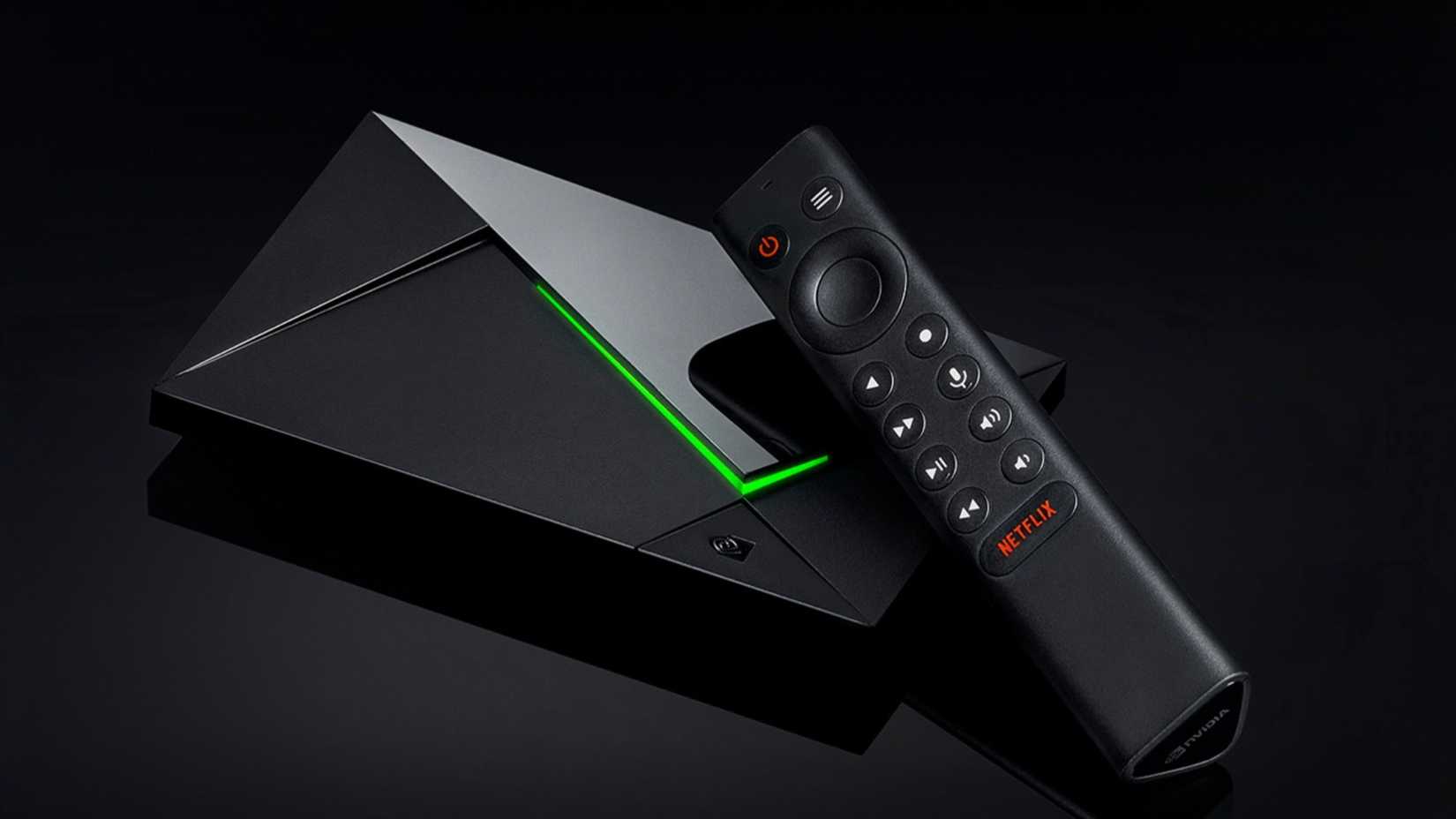 NVIDIA Shield TV Pro and remote control on black background. 