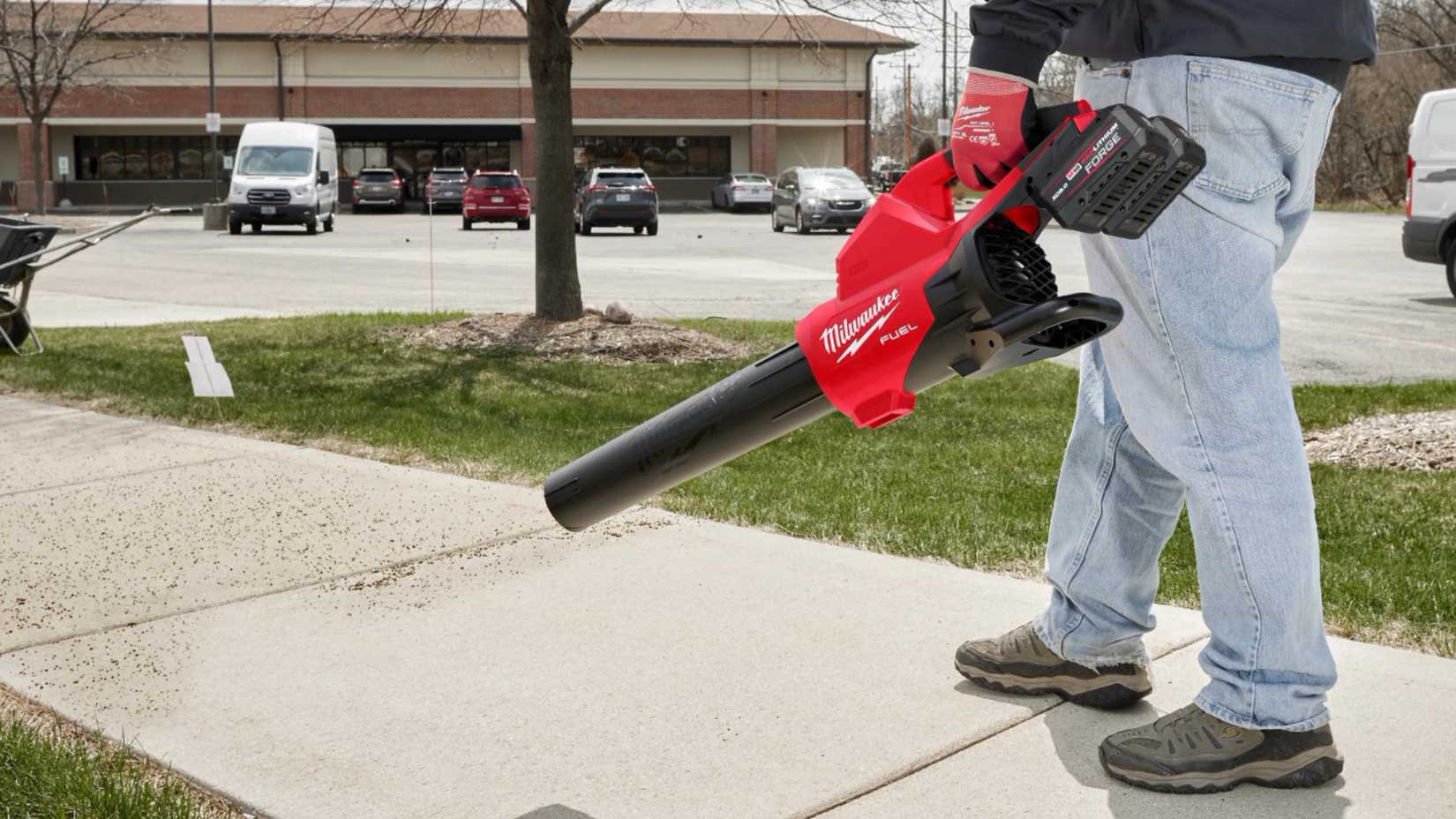person using a Milwaukee dual battery blower