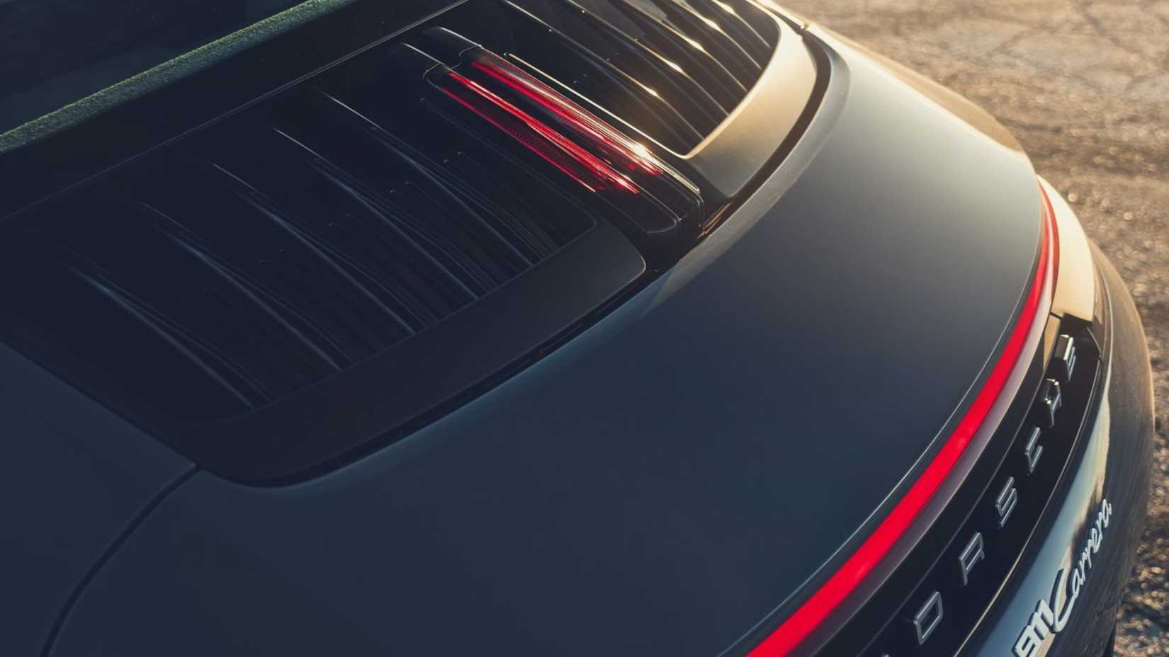 Close-up shot of the engine compartment on a gray 2025 Porsche 911 Carrera.