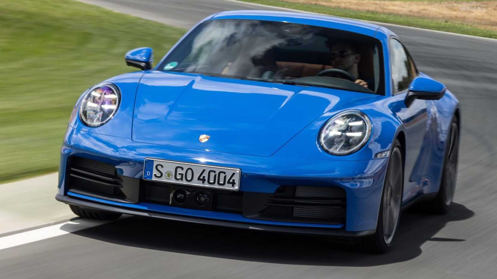 Dynamic front-end shot of a blue 2025 Porsche 911 Carrera.