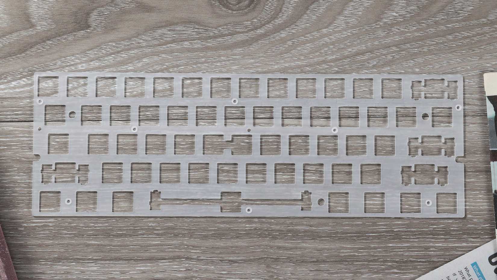 A polycarbonate plate for the Tofu Redux case lying on a table. 