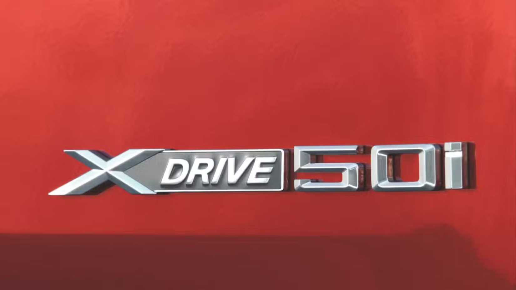 Close-up shot of the badge on the tailgate of a red 2008–2012 BMW X6 xDrive 50i.