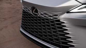 Close-up shot of the front grille on a silver 2026 Lexus RX 350h.