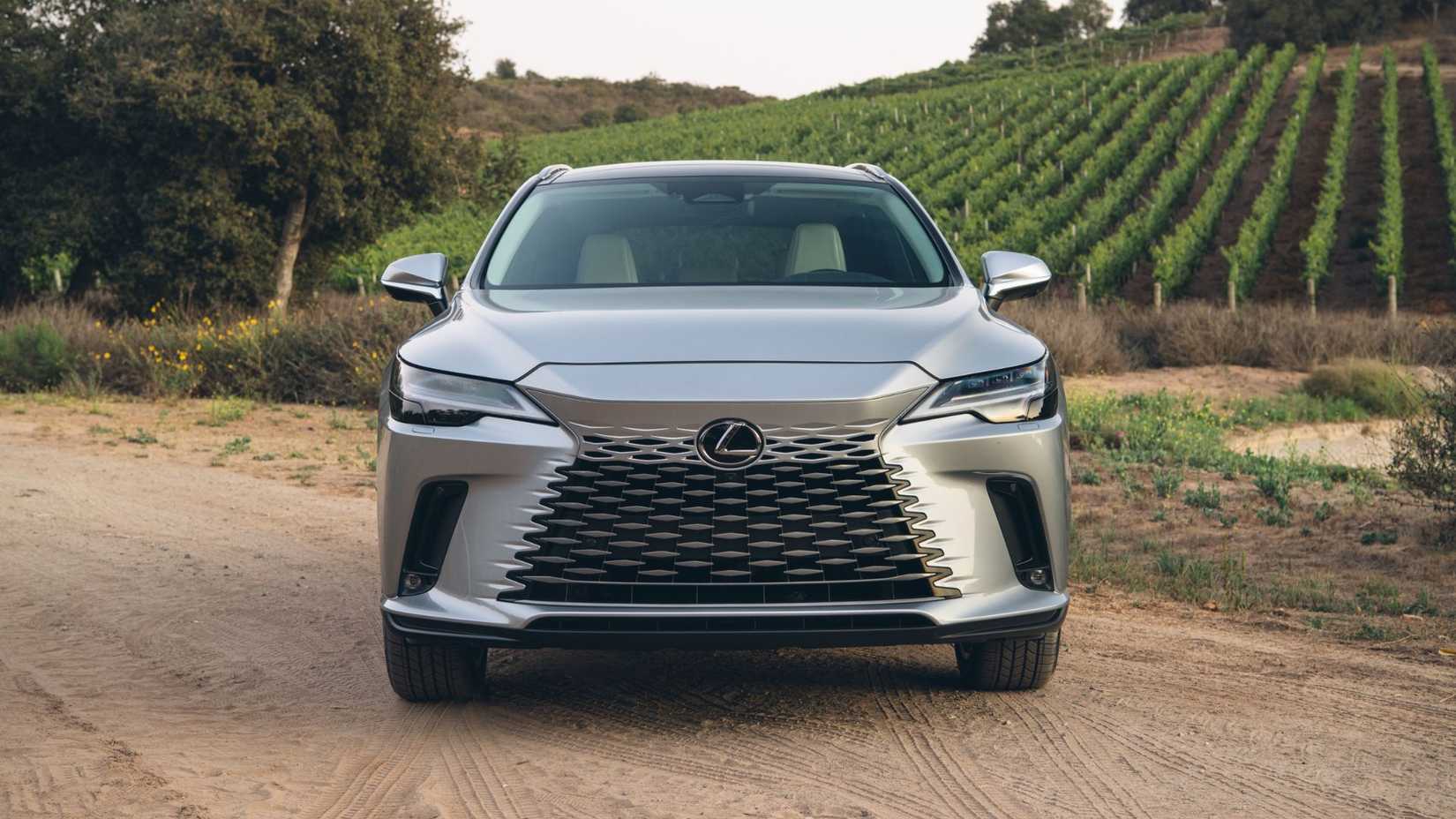 Foto estática da frente de um Lexus RX 350h 2026 prateado.