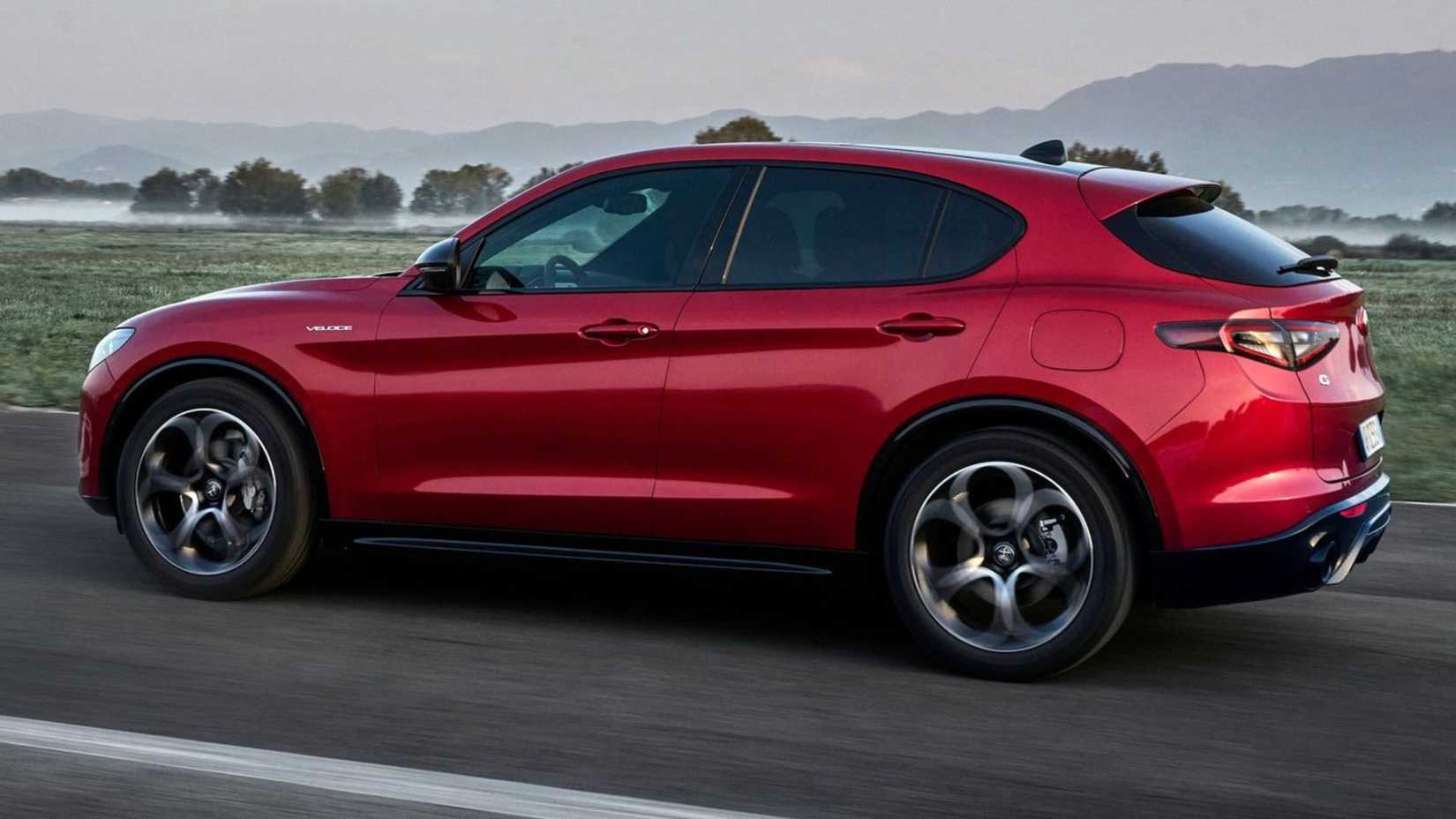 Dynamic side profile photo of a red 2023 Alfa Romeo Stelvio.