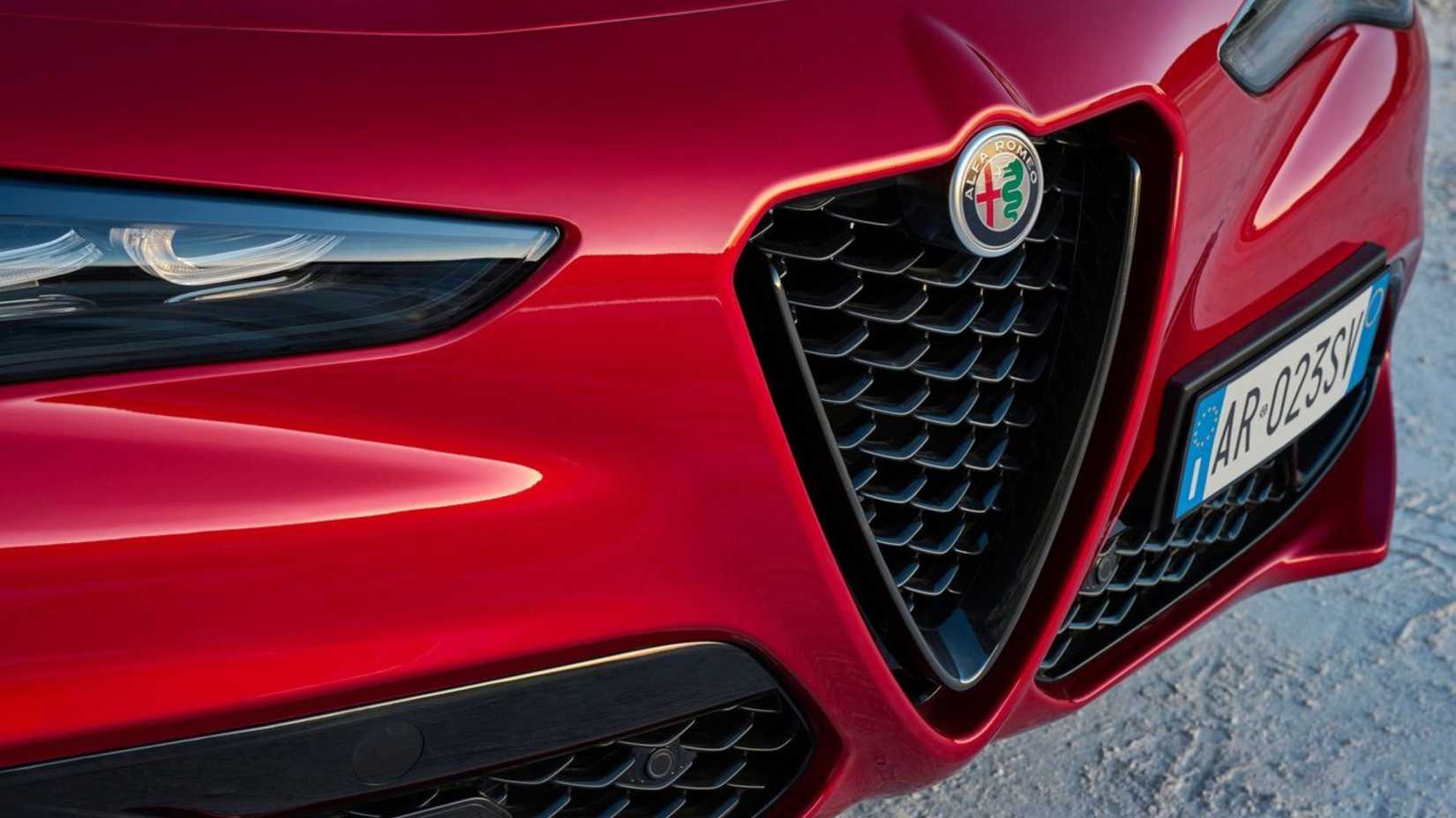 Close-up of the front grille of a red 2023 Alfa Romeo Stelvio.