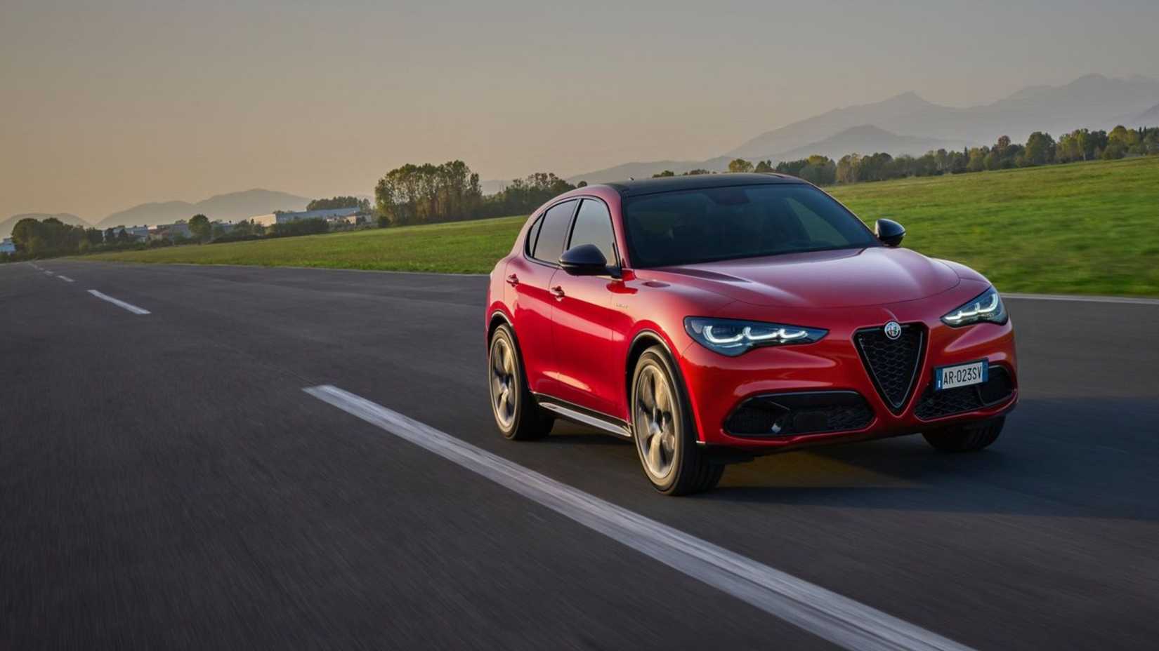 Dynamic front 3/4 shot of a red 2023 Alfa Romeo Stelvio.