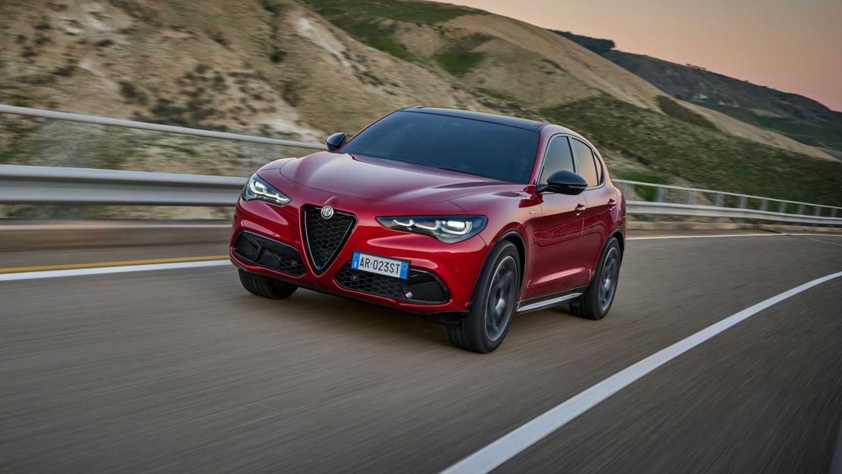 Dynamic front 3/4 shot of a red 2023 Alfa Romeo Stelvio.