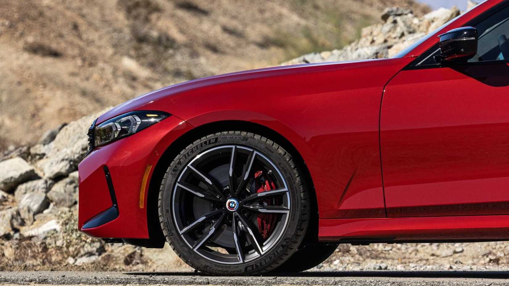 Close-up shot of the front 1/4 on a red 2023 BMW M340i.