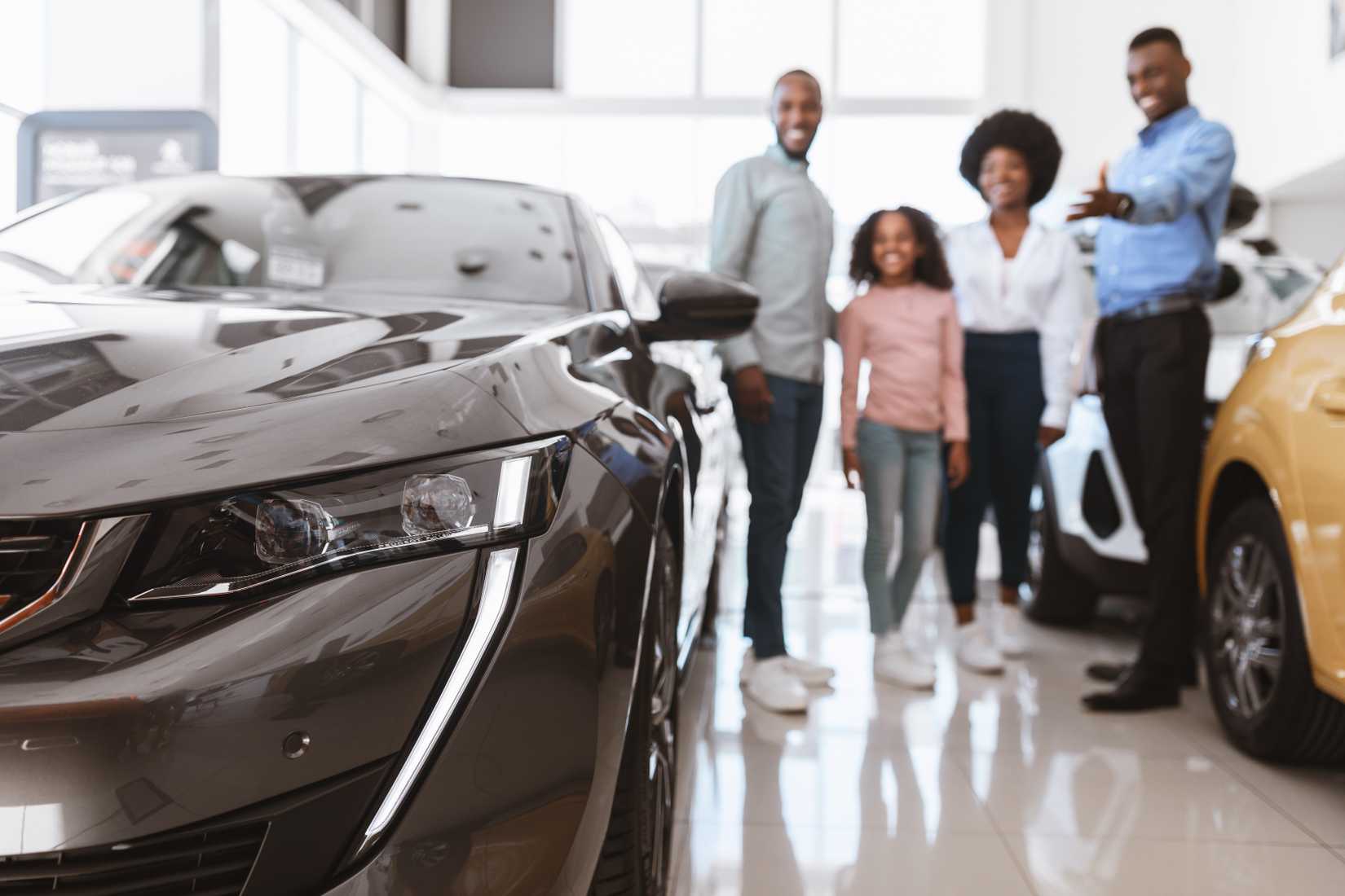 Family shopping for a new car in the showroom.