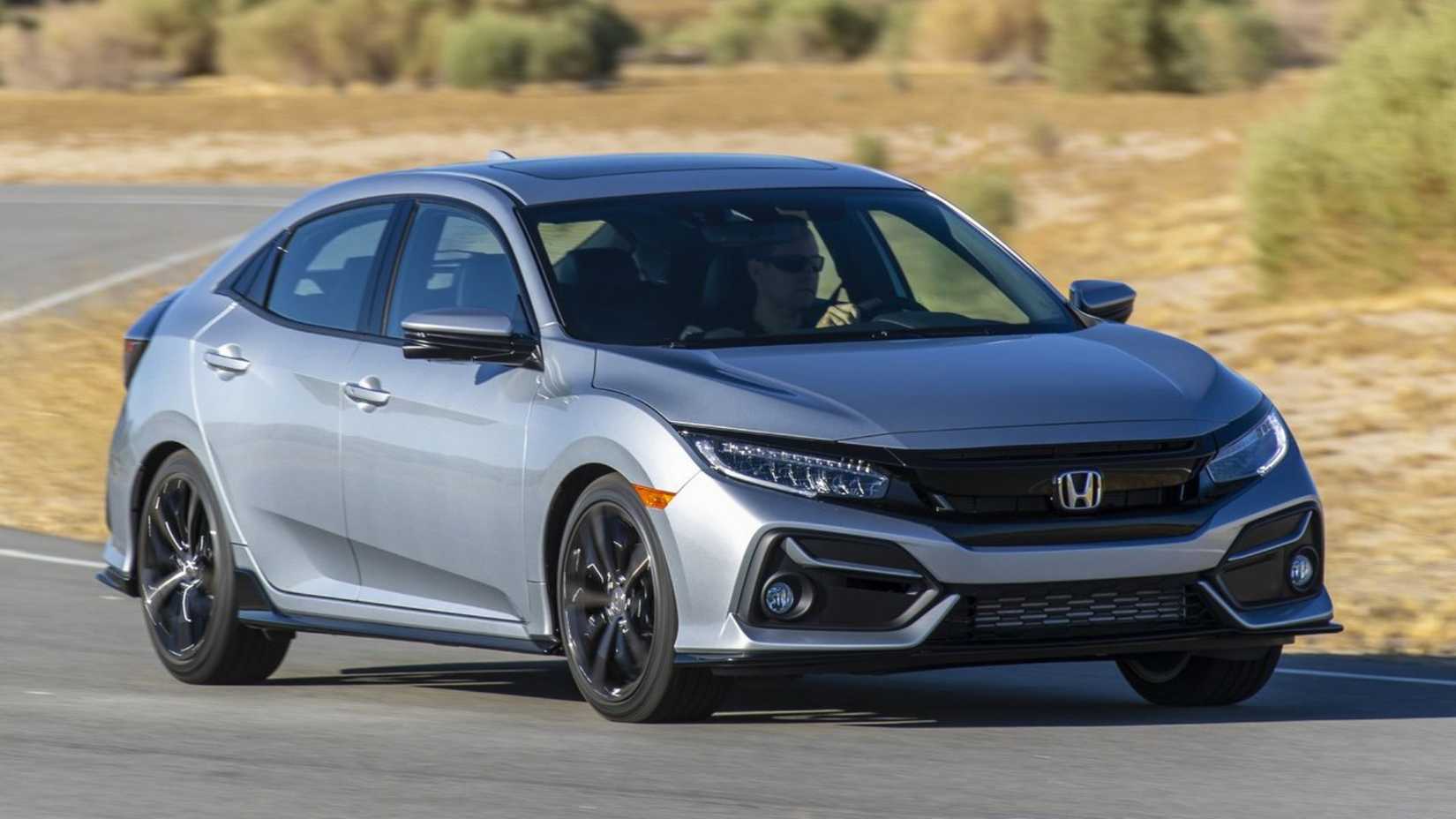 Dynamic front 3/4 shot of a silver 2020 Honda Civic Hatchback.
