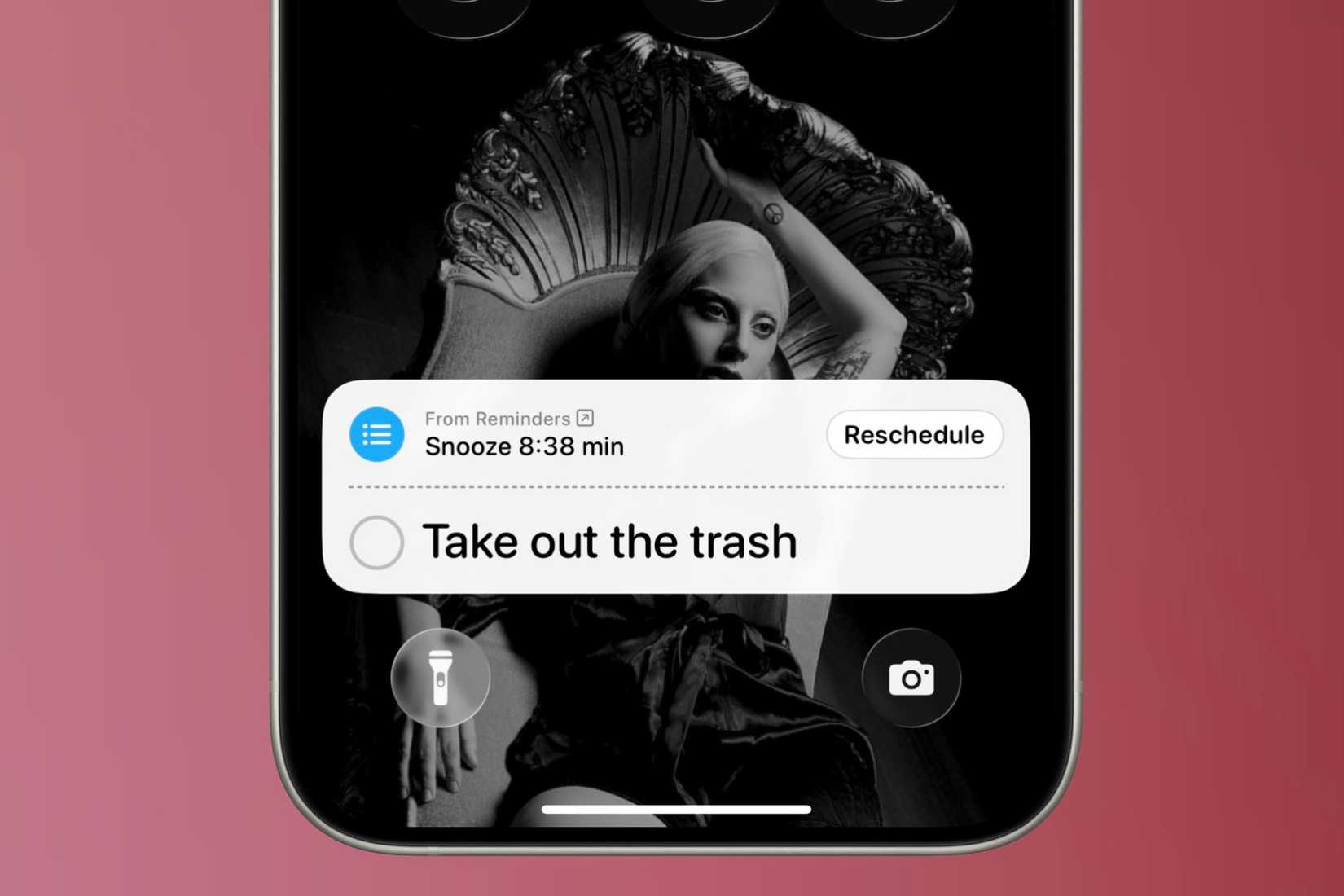 Live Activity on the lock screen counting down till it alerts you again of an urgent reminder on an iPhone in front of a colorful background.