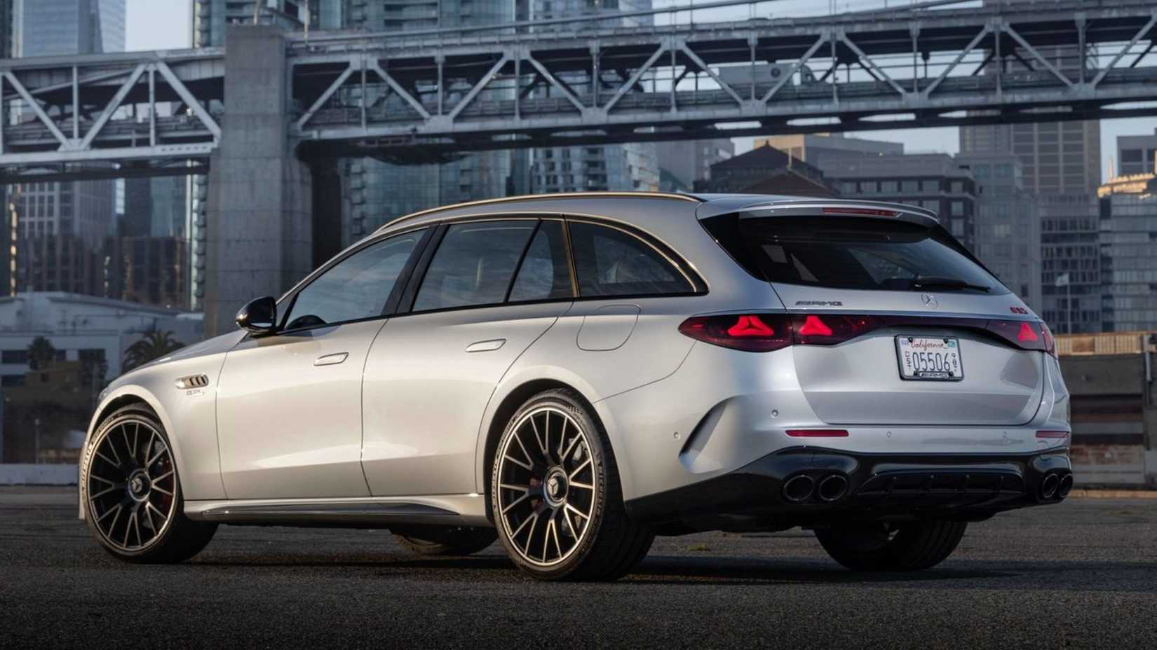 Static rear 3/4 shot of a silver 2025 Mercedes-Benz E53 AMG Hybrid Estate.
