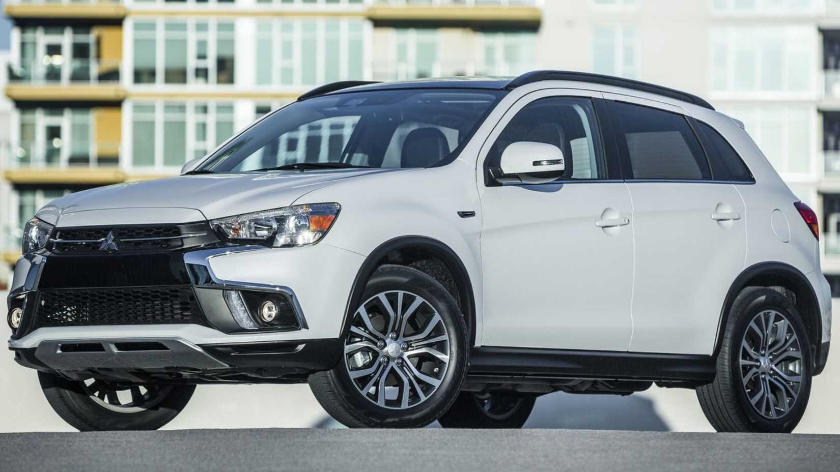Static front 3/4 shot of a white 2018 Mitsubishi Outlander Sport.