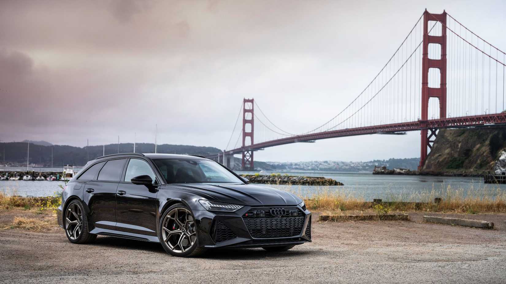 Static front 3/4 shot of a black Audi RS6 Avant Performance.