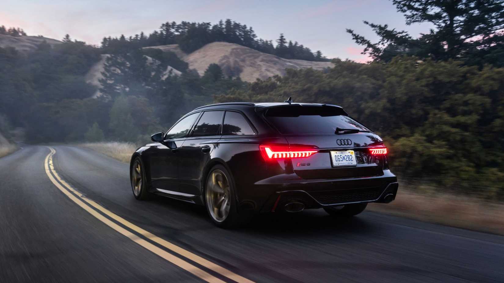 Dynamic rear 3/4 shot of a black Audi RS6 Avant Performance.