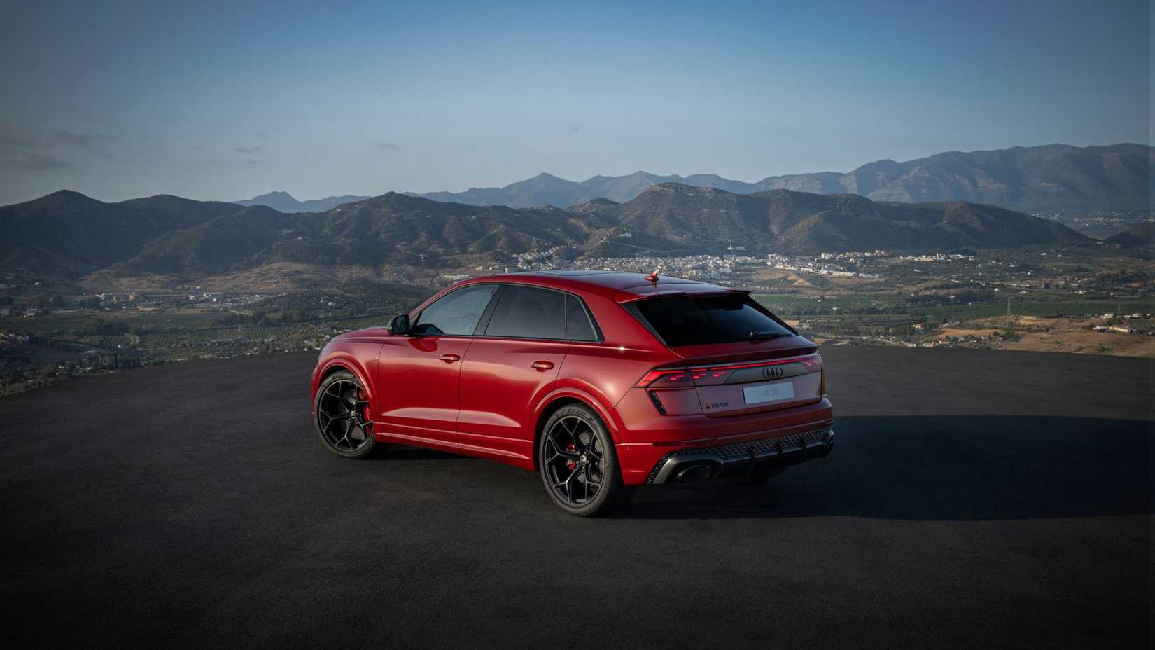 Static rear 3/4 shot of a red Audi RS Q8.