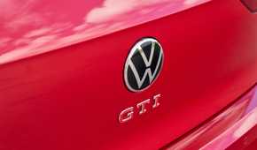 Close-up shot of the GTI badging on the tailgate of a red 2025 Volkswagen Golf GTI Autobahn.