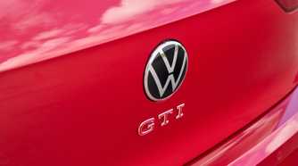 Close-up shot of the GTI badging on the tailgate of a red 2025 Volkswagen Golf GTI Autobahn.