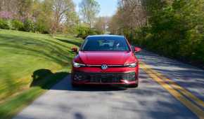 Dynamic front-end shot of a red 2025 Volkswagen Golf GTI Autobahn.