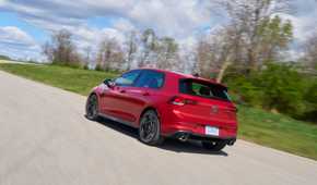 Dynamic rear 3/4 shot of a red 2025 Volkswagen Golf GTI Autobahn.