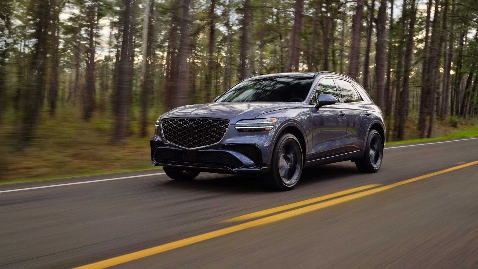 Dynamic front 3/4 shot of a gray 2026 Genesis GV70.