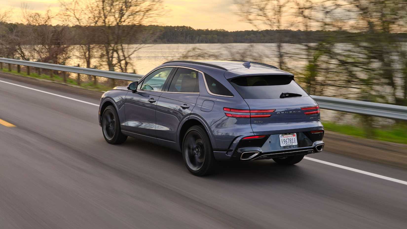 Dynamic rear 3/4 shot of a gray 2026 Genesis GV70.