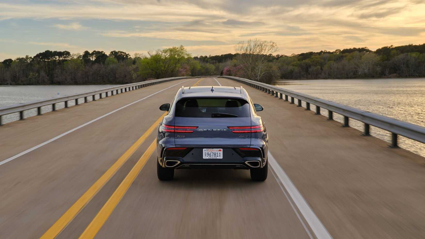 Dynamic shot of the rear of a gray 2026 Genesis GV70.