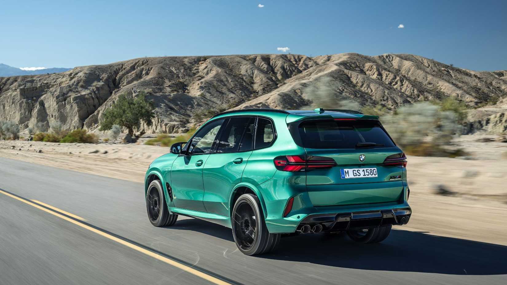 Dynamic rear 3/4 shot of a green BMW X5 M Competition.