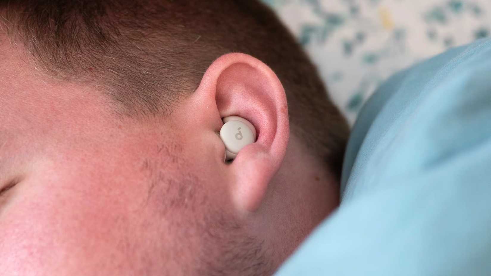Person asleep with the Soundcore Sleep A20 Bluetooth Earbuds in their ear
