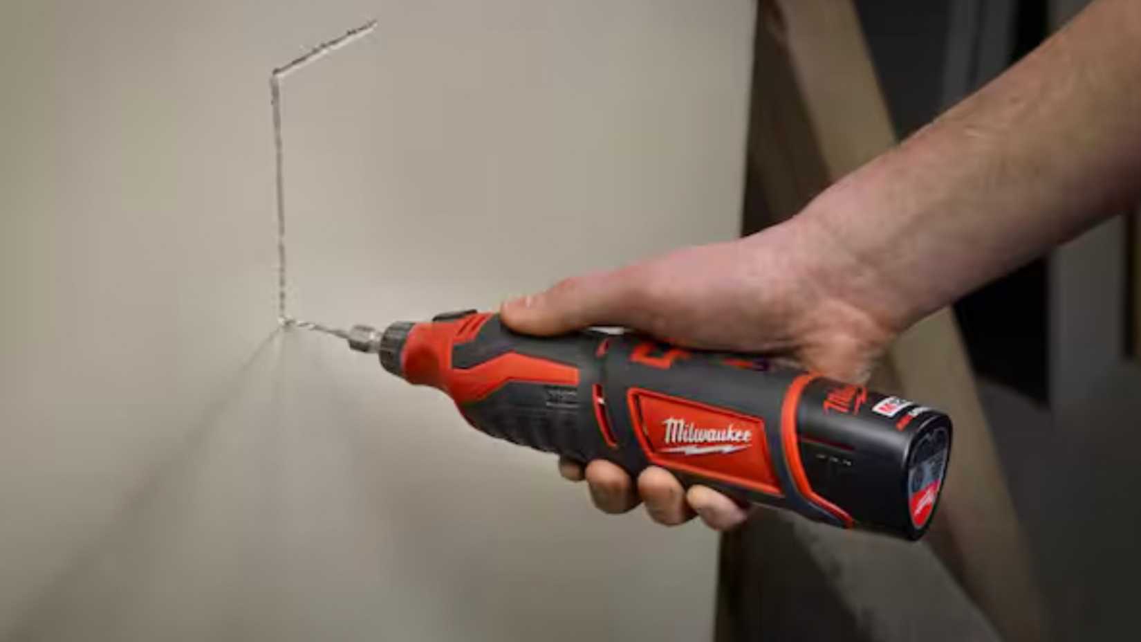 Person using a Milwaukee rotary tool