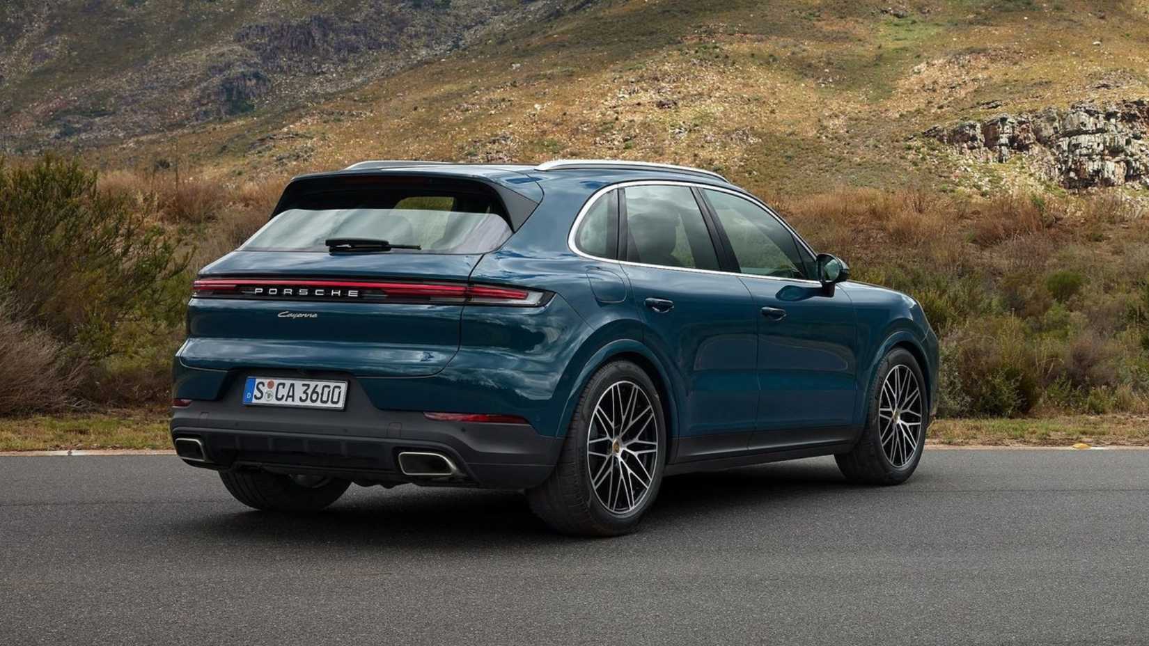 Static rear 3/4 shot of a blue 2024 Porsche Cayenne.