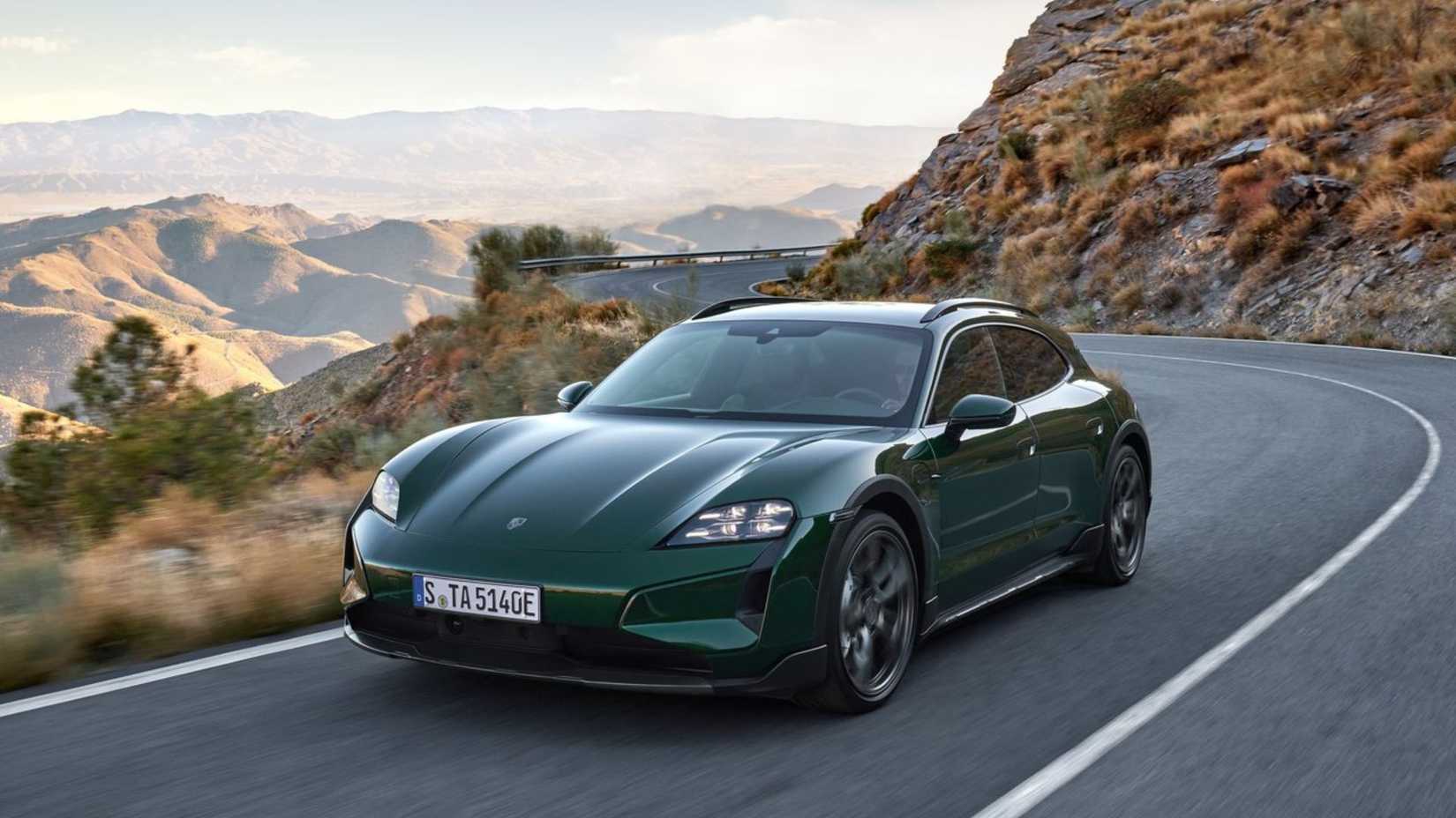 Dynamic front 3/4 shot of a green 2025 Porsche Taycan Turbo Cross Turismo.