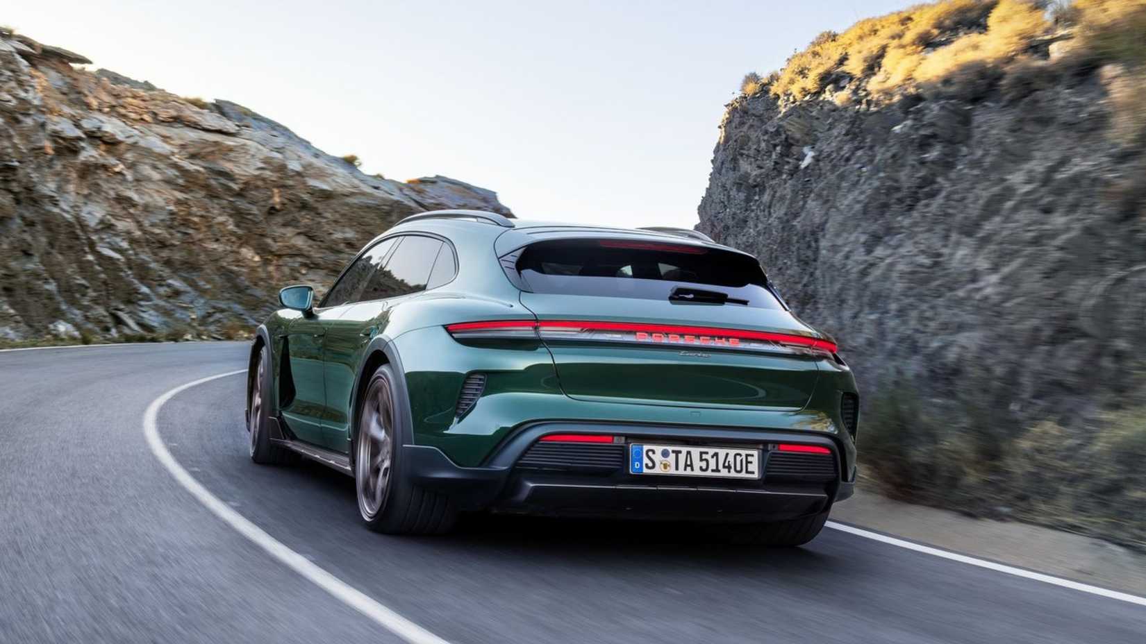 Dynamic rear 3/4 shot of a green 2025 Porsche Taycan Turbo Cross Turismo.