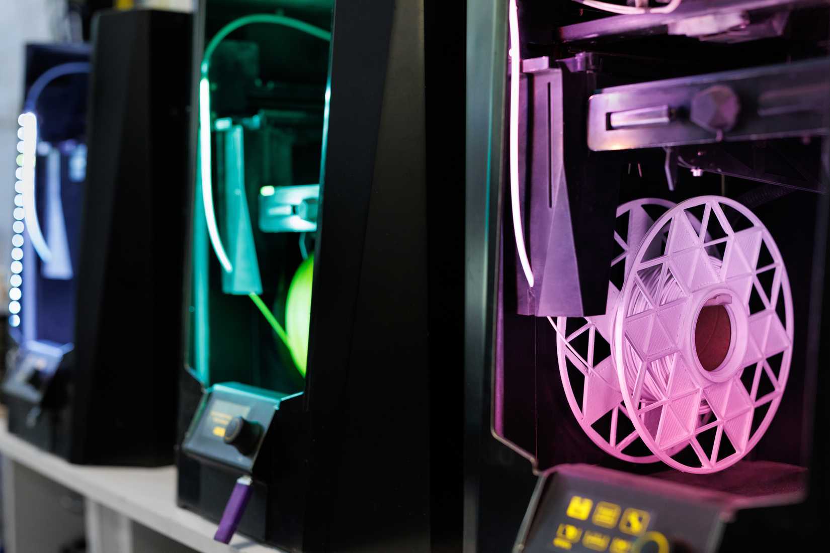 A 3D print farm showing spools mounted on the side of the printers.