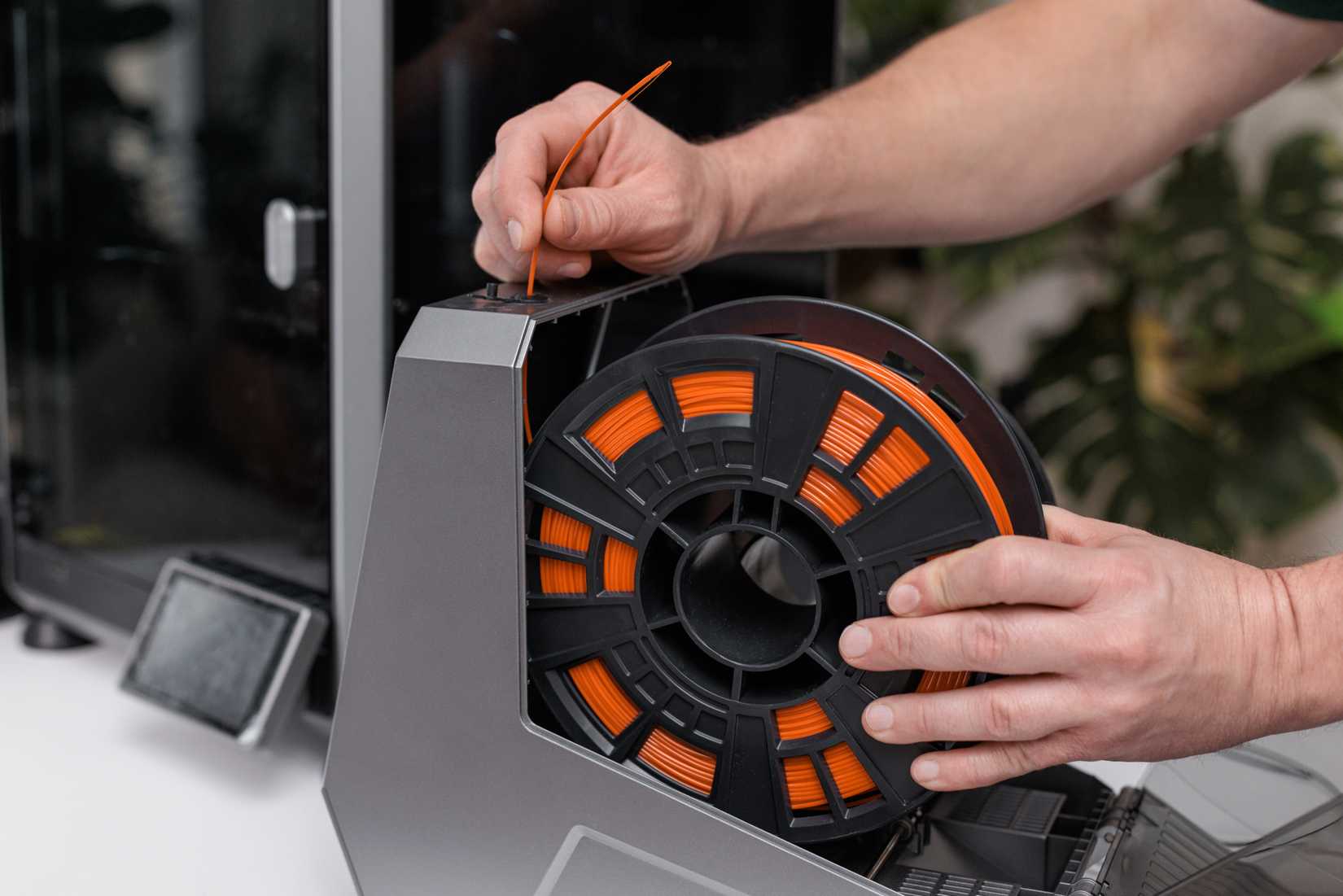 A 3D peinter filament spool in an external holder.