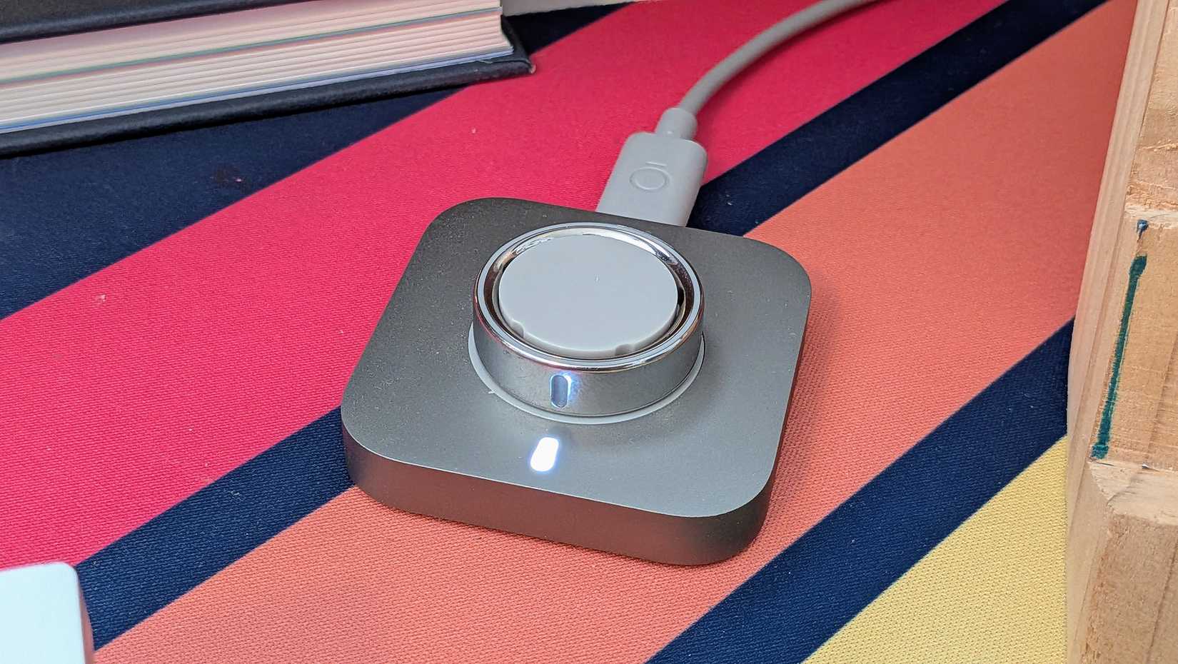 Oura Ring 4 on its charger.