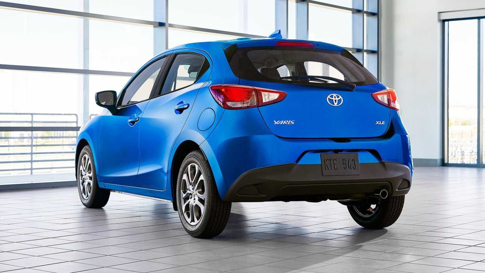 Static rear 3/4 shot of a blue 2020 Toyota Yaris Hatchback.