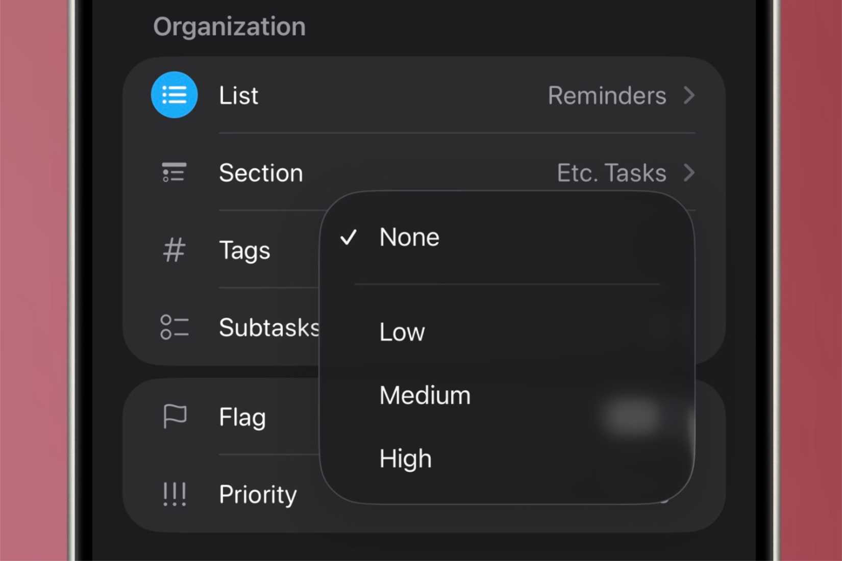 Setting the priority level of a flag to a reminder in the Reminders app in iOS on an iPhone in front of a colorful background.