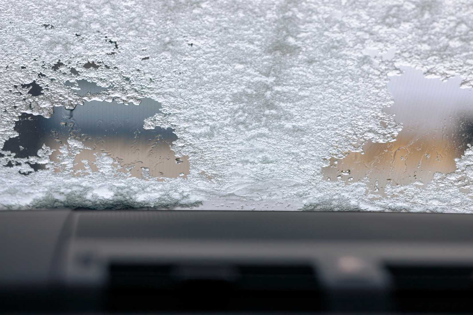 An image of a car's windshield covered in ice and snow.