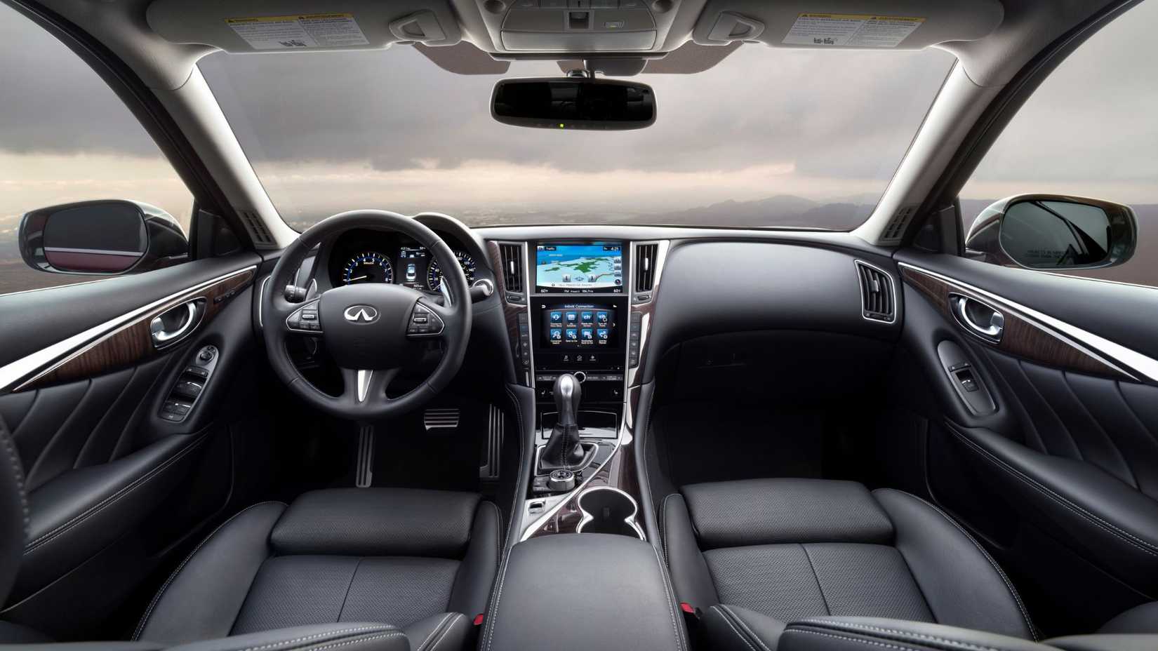Shot inside the cabin of a 2016 Infiniti Q50 Red Sport 400, showing the black leather interior and dashboard.