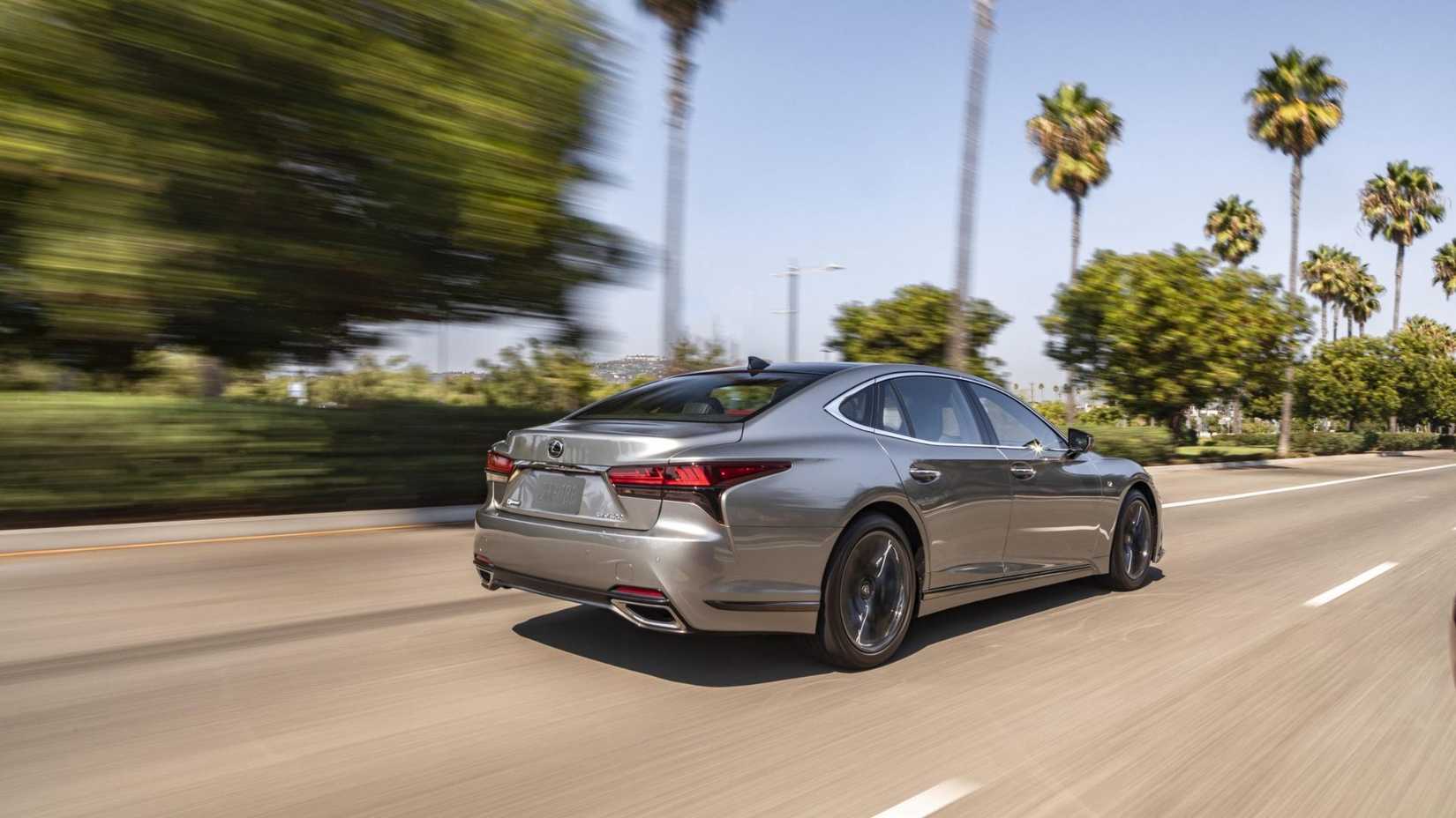Dynamic rear 3/4 shot of a silver 2025 Lexus LS 500 F-Sport.