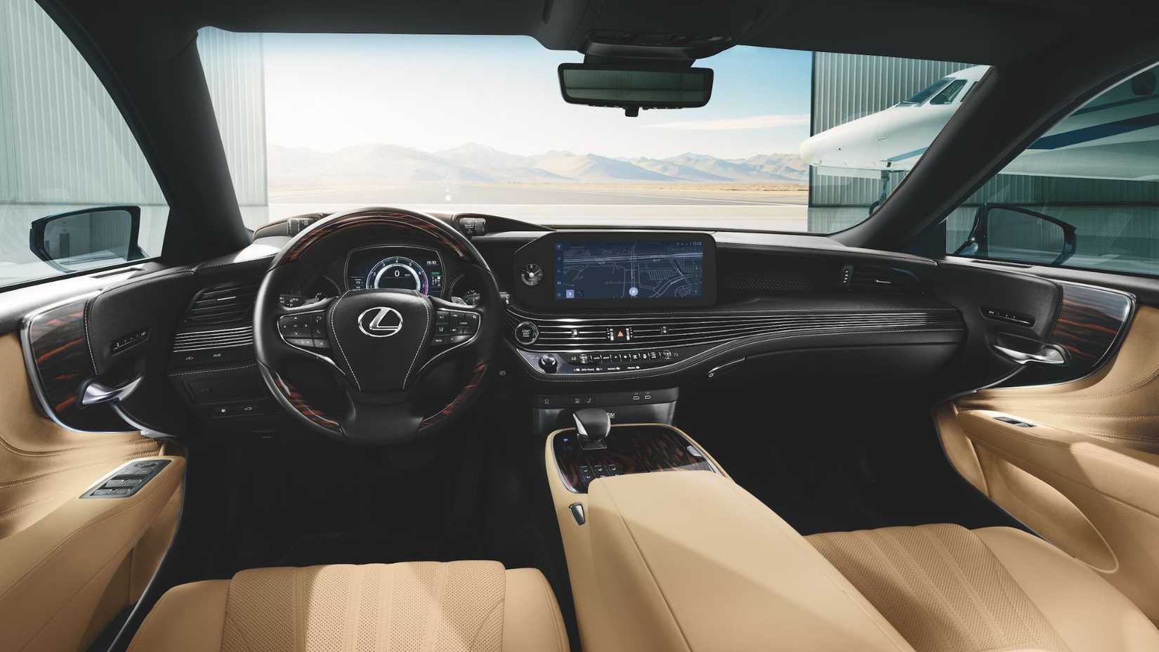 Shot inside the cabin of a 2025 Lexus LS 500, showing the cream leather seats and dashboard.