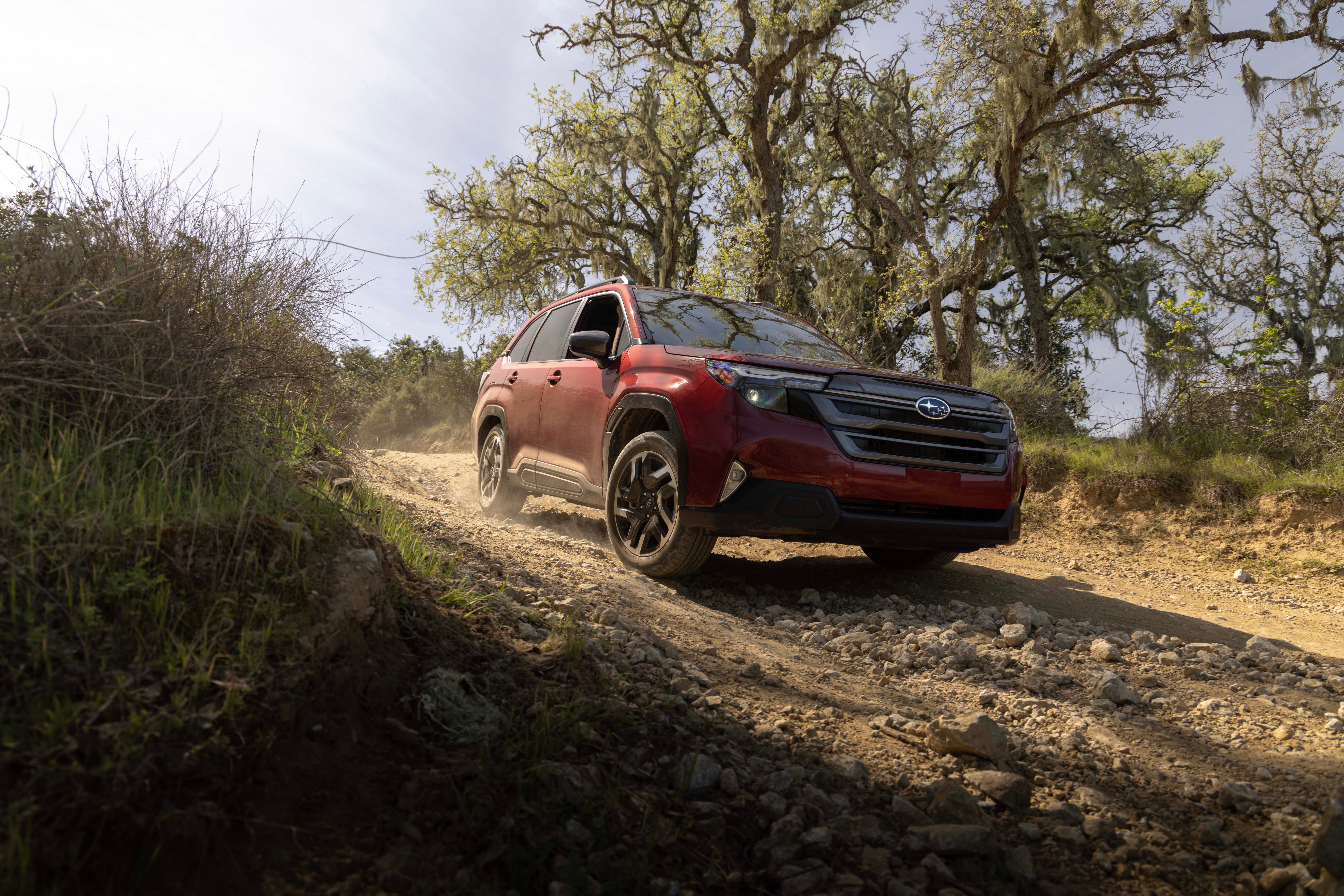 2026 Subaru Forester Hybrid driving on a dirt trail 