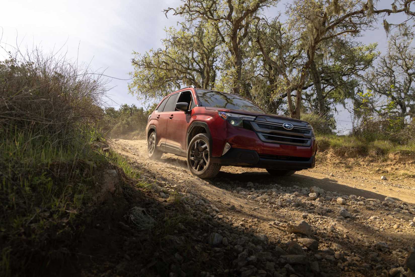 2026 Subaru Forester Hybrid driving on a dirt trail 
